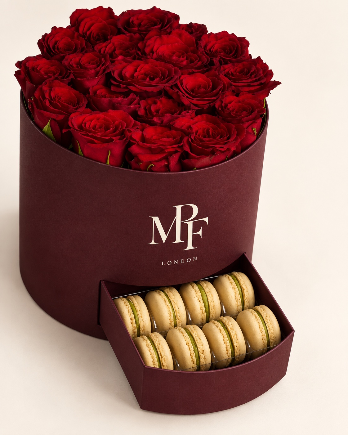 Burgundy rose box with red blooms and a drawer containing colourful macarons